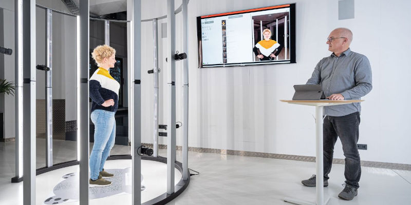 A woman standing on a platform being scanned